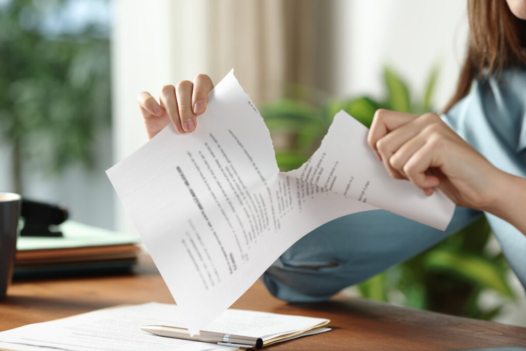 Close up portrait of a businesswoman hands breaking contract at office